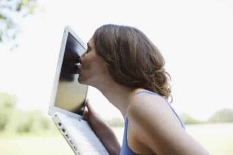 Woman kissing laptop
