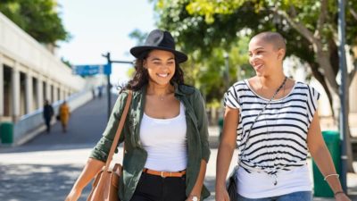 Two women friends sightseeing in summer while on vacation.