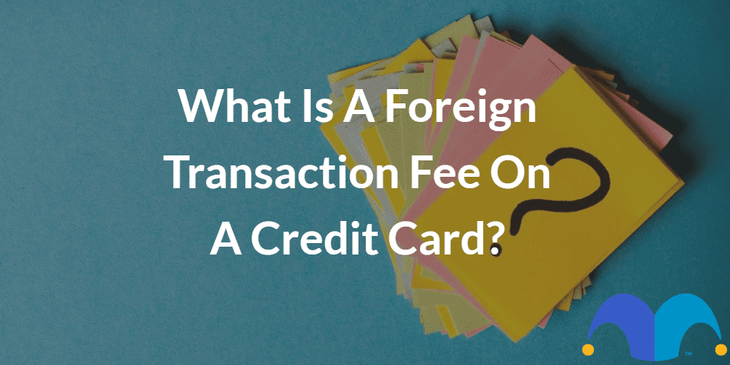 Post-it notes with question mark with the text “What is a foreign transaction fee on a credit card?” and The Motley Fool jester cap logo